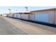 View of garages in a well-maintained community, with a view of an American flag at 16827 N 103Rd Ave, Sun City, AZ 85351