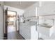 Bright laundry room featuring a washer, dryer, sink and additional cabinets at 16827 N 103Rd Ave, Sun City, AZ 85351