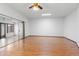 A very large living area has laminate flooring, a fan, and slider doors at 16827 N 103Rd Ave, Sun City, AZ 85351