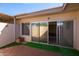 Brick-paved patio offers indoor-outdoor living with artificial turf and sliding glass door to the home at 16827 N 103Rd Ave, Sun City, AZ 85351
