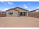The backyard features a simple, compact design with a partial patio and minimal landscaping, offering a blank canvas at 17033 W Royal Palm Rd, Waddell, AZ 85355