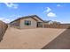 Spacious backyard featuring a simple design with partial landscaping and a block wall, creating an open outdoor space at 17033 W Royal Palm Rd, Waddell, AZ 85355