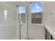 Modern bathroom featuring glass enclosed shower, window, and tile floors at 17033 W Royal Palm Rd, Waddell, AZ 85355