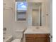 Bright bathroom featuring wood vanity, white countertops, and tub with shower at 17033 W Royal Palm Rd, Waddell, AZ 85355