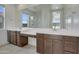 Bathroom featuring dual sinks, quartz countertops, and a large mirror offering plenty of vanity space at 17033 W Royal Palm Rd, Waddell, AZ 85355