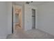 Bright bedroom featuring a closet with sliding doors and a doorway to another room at 17033 W Royal Palm Rd, Waddell, AZ 85355