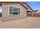 Back exterior view with stucco and a covered patio, illustrating a well-maintained home design with neutral colors at 17033 W Royal Palm Rd, Waddell, AZ 85355