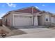 Single-story home featuring a two-car garage and xeriscaping at 17033 W Royal Palm Rd, Waddell, AZ 85355