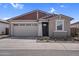 Charming single-story home featuring a two-car garage and low-maintenance desert landscaping at 17033 W Royal Palm Rd, Waddell, AZ 85355