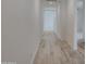 View of a neutrally painted hallway featuring ceramic wood-look flooring at 17033 W Royal Palm Rd, Waddell, AZ 85355