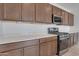 Close up of the kitchen featuring the stainless steel appliances, range and countertop space at 17033 W Royal Palm Rd, Waddell, AZ 85355