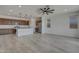 A kitchen that is completed with a large island, stainless steel appliances and designer lighting at 17033 W Royal Palm Rd, Waddell, AZ 85355
