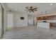 Spacious living area showing the open floor plan, tile floors and access to the kitchen at 17033 W Royal Palm Rd, Waddell, AZ 85355