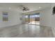 Living room with large sliding glass doors with access to the outdoor space and backyard at 17033 W Royal Palm Rd, Waddell, AZ 85355