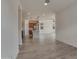 Open-concept living room flows into the kitchen, featuring modern lighting and neutral color palette at 17033 W Royal Palm Rd, Waddell, AZ 85355