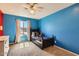 Bright bedroom with blue walls, a ceiling fan, and a cozy dark wood twin bed filled with pillows and a teddy bear at 17246 N 56Th Way, Scottsdale, AZ 85254