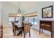 Bright dining room with a stylish chandelier, large windows overlooking the pool, and elegant decor at 17246 N 56Th Way, Scottsdale, AZ 85254