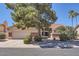 Charming single-story home featuring a two-car garage, stone accents, tile roof, and mature desert landscaping at 17246 N 56Th Way, Scottsdale, AZ 85254