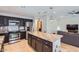 Modern kitchen with stainless steel appliances, granite countertops, and a center island open to the living space at 17246 N 56Th Way, Scottsdale, AZ 85254