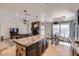 Modern kitchen with large island, stainless appliances, dark cabinetry, adjacent to fireplace and breakfast nook at 17246 N 56Th Way, Scottsdale, AZ 85254