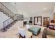 Spacious living room with a staircase, natural light, tiled floors and elegant furnishings creating a comfortable atmosphere at 17246 N 56Th Way, Scottsdale, AZ 85254