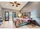 Main bedroom with high ceilings, a ceiling fan, access to a private balcony and ensuite bathroom at 17246 N 56Th Way, Scottsdale, AZ 85254