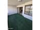 Enclosed balcony area with green carpeting, offering a private outdoor space at 17404 N 99Th Ave # 214, Sun City, AZ 85373