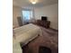 Relaxing bedroom featuring a comfortable queen bed and large window with natural light at 17404 N 99Th Ave # 214, Sun City, AZ 85373