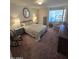 Cozy bedroom with ample natural light, comfortable seating, and a spacious dresser at 17404 N 99Th Ave # 214, Sun City, AZ 85373