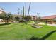 Beautiful community grounds with lush green grass and mature trees at 17404 N 99Th Ave # 214, Sun City, AZ 85373
