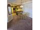 Open floor plan dining area with glass table adjacent to the kitchen with a breakfast bar at 17404 N 99Th Ave # 214, Sun City, AZ 85373