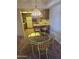 Cozy dining area with glass table adjacent to kitchen with breakfast bar at 17404 N 99Th Ave # 214, Sun City, AZ 85373