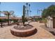 Well maintained community grounds with cacti, palm trees and other plants at 17404 N 99Th Ave # 214, Sun City, AZ 85373