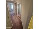 Hallway with a mirror, leading to a living area, with carpeted floors at 17404 N 99Th Ave # 214, Sun City, AZ 85373