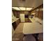 Cozy kitchen featuring wood cabinetry, white appliances, and ample countertop space at 17404 N 99Th Ave # 214, Sun City, AZ 85373