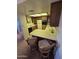 Bright kitchen with light countertops, wooden cabinets, and a cozy breakfast bar area at 17404 N 99Th Ave # 214, Sun City, AZ 85373
