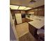 Cozy kitchen featuring wood cabinets, white appliances, and a breakfast bar at 17404 N 99Th Ave # 214, Sun City, AZ 85373