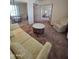 Spacious living room featuring neutral tones, sofa, seating, and a mirrored wall at 17404 N 99Th Ave # 214, Sun City, AZ 85373