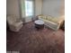 Comfortable living room with a sofa, armchair, coffee table, and carpet at 17404 N 99Th Ave # 214, Sun City, AZ 85373