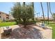 Charming patio area with comfortable seating, brick pavers, and lush landscaping for relaxing outdoors at 17404 N 99Th Ave # 214, Sun City, AZ 85373