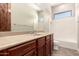 The primary bathroom includes a wide mirror, a vanity, and tile floors at 17953 W Willow Dr, Goodyear, AZ 85338