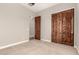 An additional bedroom features carpet and wood paneled closet doors at 17953 W Willow Dr, Goodyear, AZ 85338