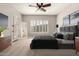 Serene bedroom featuring neutral tones, shuttered windows, and plush bedding for a restful retreat at 17953 W Willow Dr, Goodyear, AZ 85338