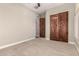 Bedroom featuring neutral walls and carpet, with wood closet doors at 17953 W Willow Dr, Goodyear, AZ 85338