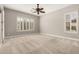 Bedroom with neutral walls and carpet, ceiling fan, and shuttered windows providing plenty of natural light at 17953 W Willow Dr, Goodyear, AZ 85338