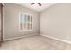 An additional bedroom featuring carpet and a shuttered window provides ample natural light at 17953 W Willow Dr, Goodyear, AZ 85338