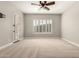 Bedroom featuring neutral walls and carpet, ceiling fan, and a door leading to the outside at 17953 W Willow Dr, Goodyear, AZ 85338