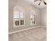 Bedroom with neutral walls and carpet, ceiling fan, and shuttered windows providing plenty of natural light at 17953 W Willow Dr, Goodyear, AZ 85338