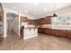 Spacious kitchen features stainless steel appliances, granite counters, tile flooring and ample cabinet space at 17953 W Willow Dr, Goodyear, AZ 85338