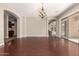 Open-concept living space featuring hardwood flooring and a stylish chandelier for elegant illumination at 17953 W Willow Dr, Goodyear, AZ 85338